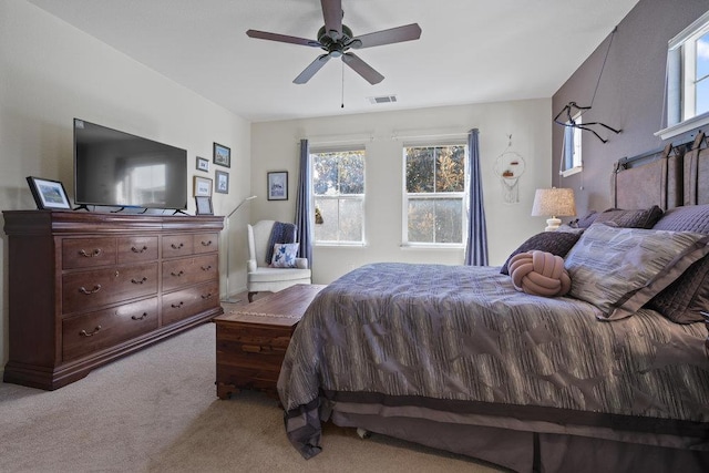 bedroom featuring ceiling fan and light carpet