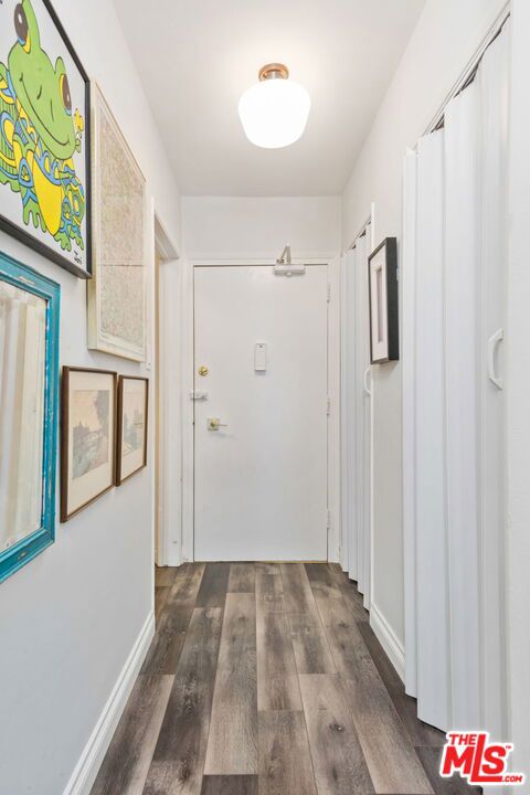 corridor featuring dark hardwood / wood-style floors