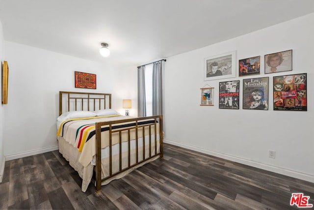 bedroom with dark hardwood / wood-style floors