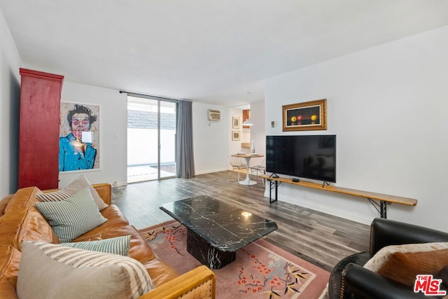 living room featuring a wall of windows, hardwood / wood-style floors, and a wall mounted air conditioner