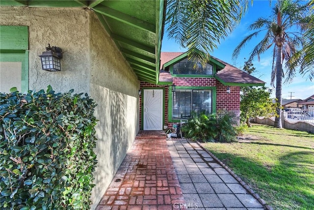 property entrance with a yard