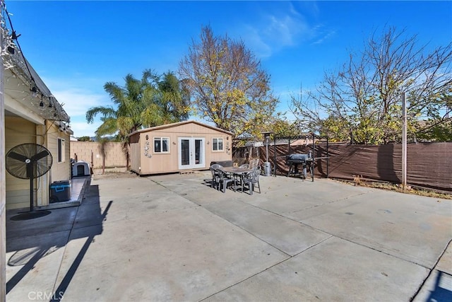 view of patio / terrace with an outbuilding and french doors