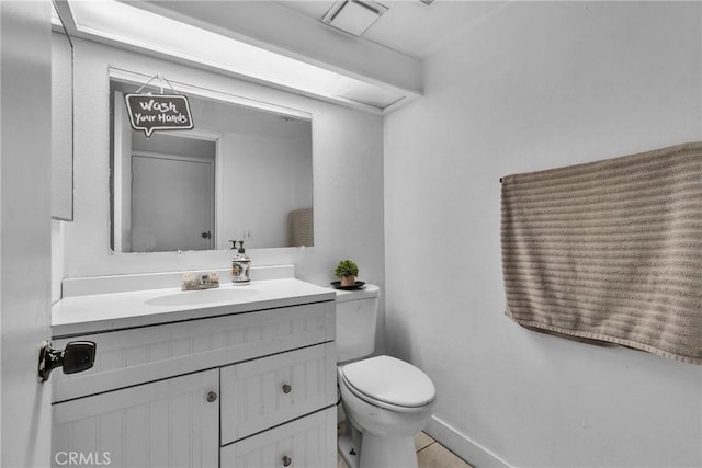 bathroom featuring toilet and vanity