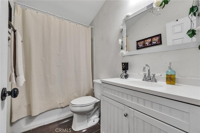 full bathroom featuring toilet, shower / bathtub combination with curtain, vanity, and wood finished floors