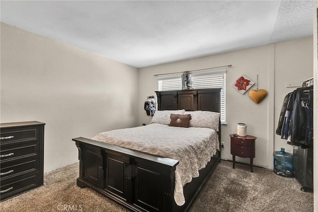 bedroom featuring dark colored carpet