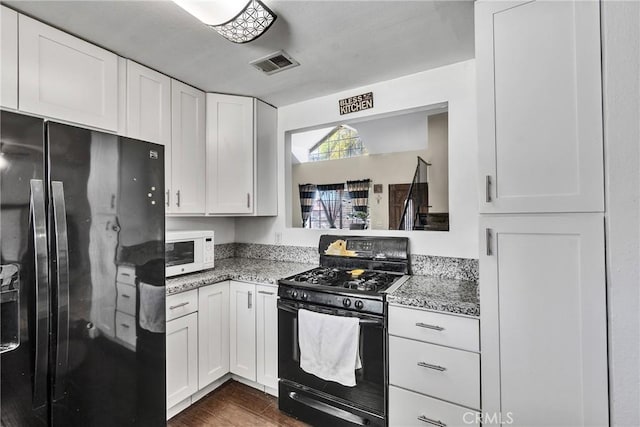 kitchen featuring visible vents, white cabinetry, black appliances, and dark wood-style floors