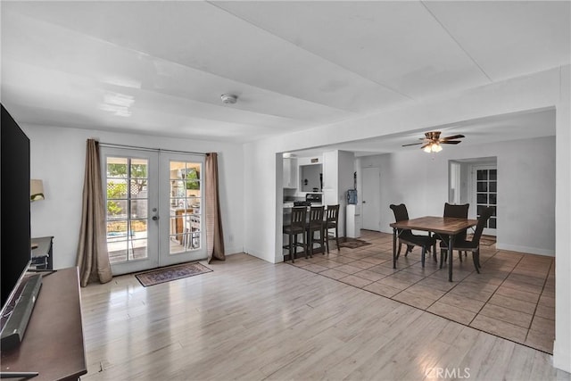 dining space featuring ceiling fan, light hardwood / wood-style flooring, and french doors