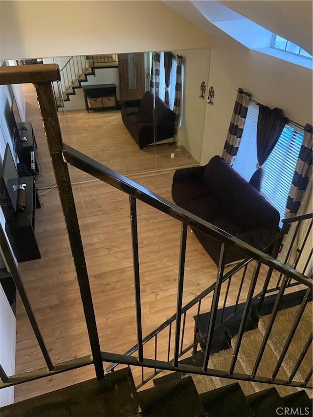 stairs featuring wood finished floors