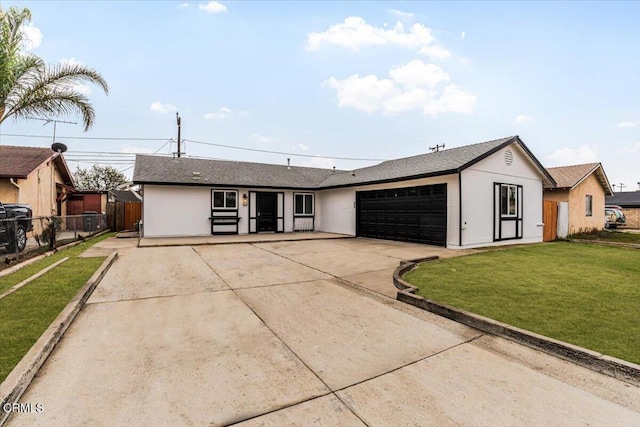 single story home featuring a front lawn and a garage