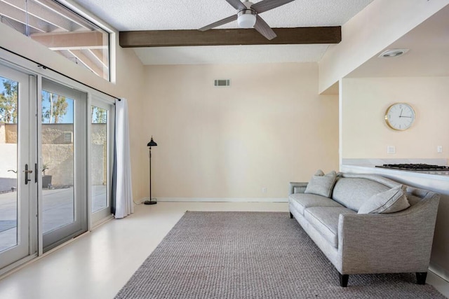 living room with a textured ceiling, ceiling fan, beam ceiling, and french doors