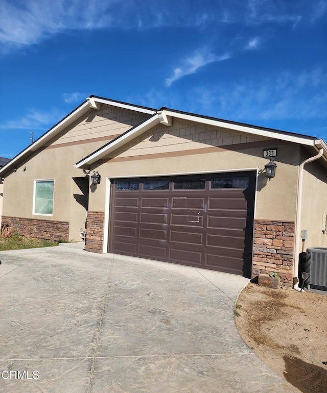 view of front of home featuring a garage and cooling unit