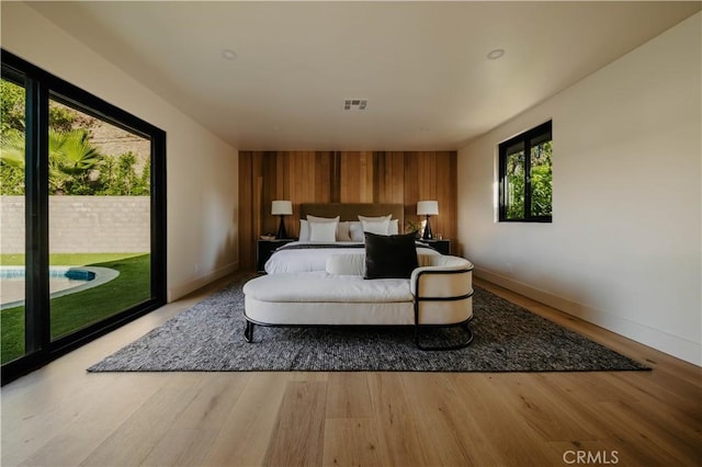 bedroom with light hardwood / wood-style flooring and access to outside