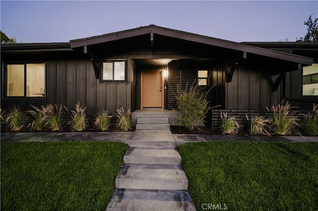 exterior entry at dusk with a yard