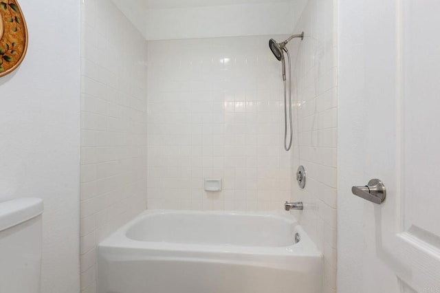 bathroom featuring bathtub / shower combination and toilet