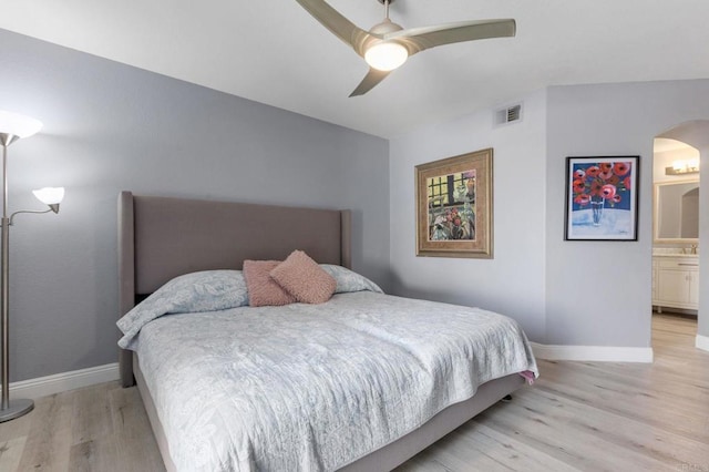 bedroom with ceiling fan, light hardwood / wood-style floors, and connected bathroom