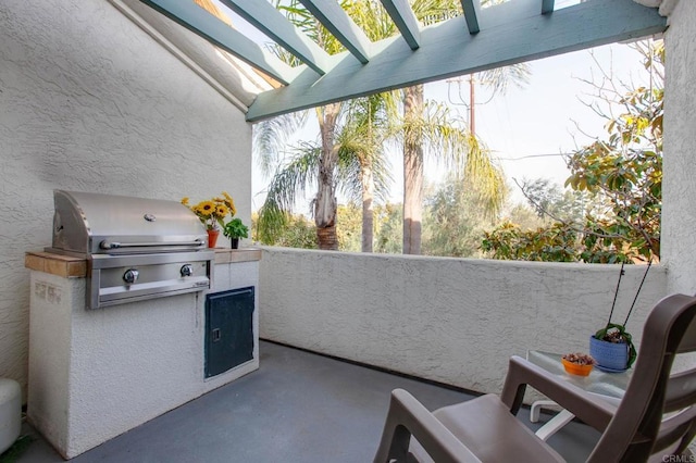 balcony featuring an outdoor kitchen, a pergola, and area for grilling