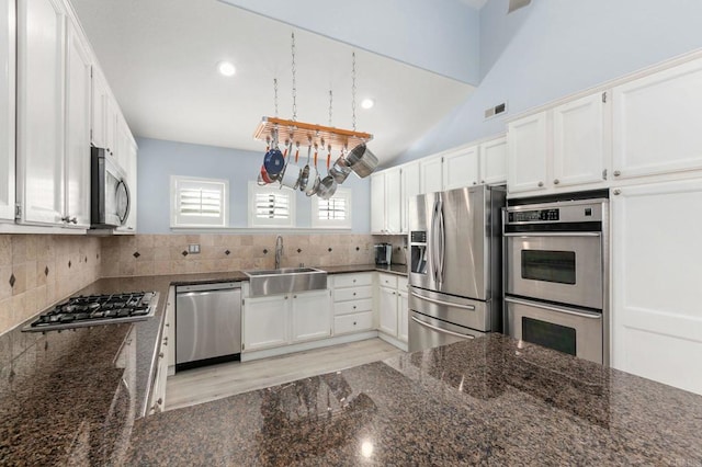 kitchen with sink, white cabinets, tasteful backsplash, and appliances with stainless steel finishes