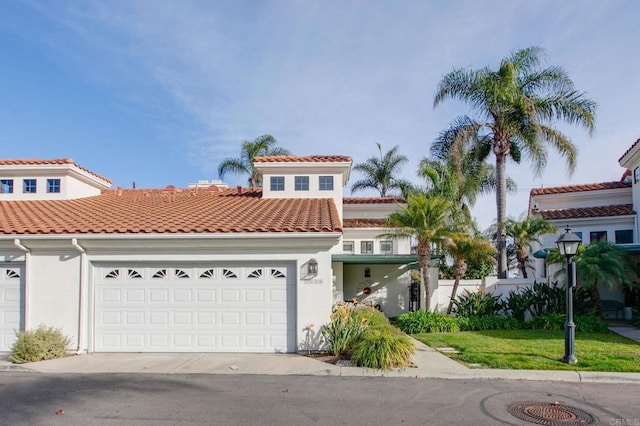 mediterranean / spanish-style home with a garage