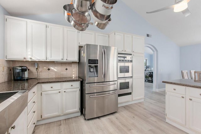 kitchen featuring white cabinetry, light hardwood / wood-style flooring, appliances with stainless steel finishes, and tasteful backsplash