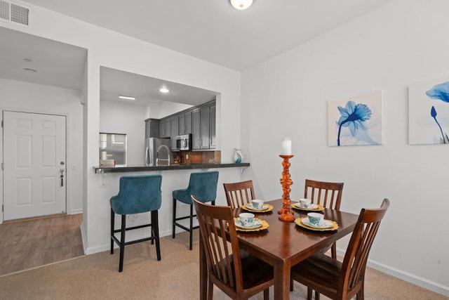 dining room with light colored carpet