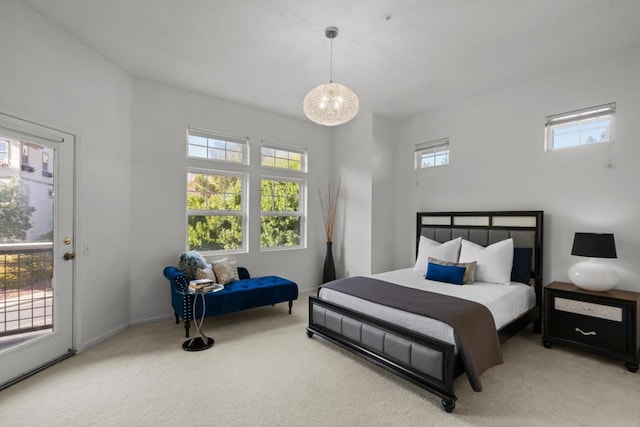 bedroom featuring multiple windows, carpet floors, and access to outside