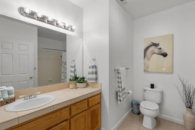 bathroom featuring tile patterned flooring, vanity, walk in shower, and toilet