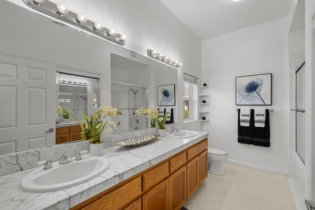 bathroom with vanity, a shower with door, and toilet