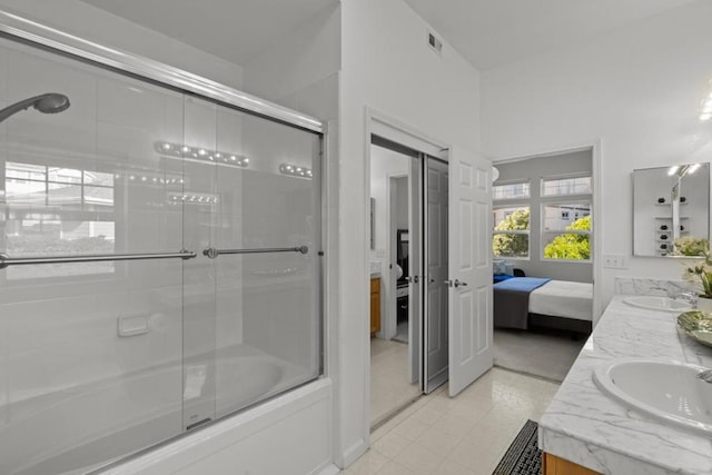 bathroom featuring vanity and combined bath / shower with glass door