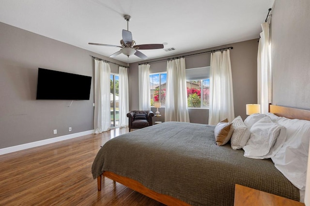 bedroom with ceiling fan and hardwood / wood-style flooring