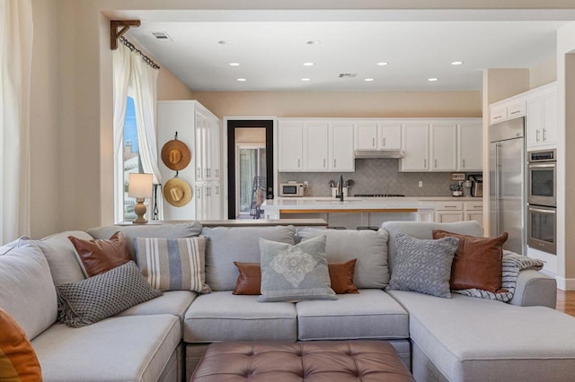 living room with sink and hardwood / wood-style flooring