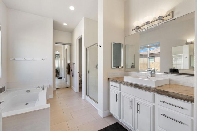 bathroom featuring separate shower and tub, vanity, and tile patterned floors