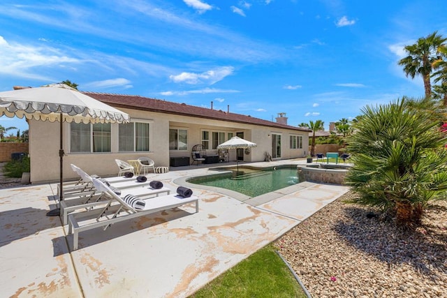 view of swimming pool with a patio area and an in ground hot tub