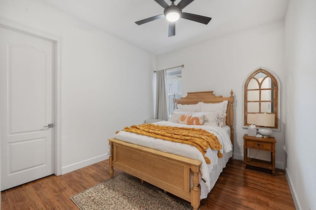 bedroom with ceiling fan and dark hardwood / wood-style floors