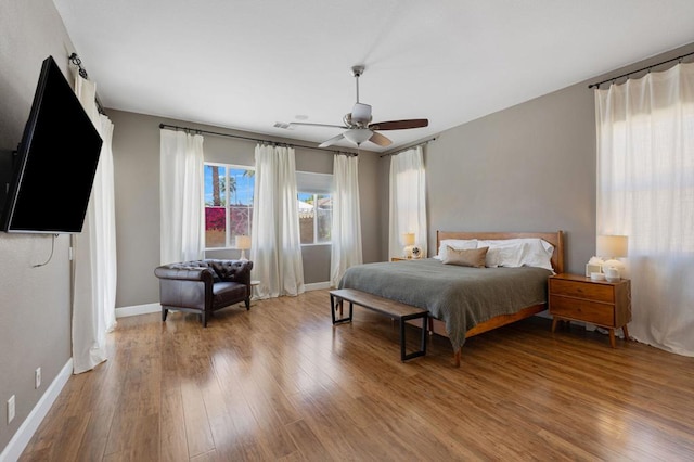 bedroom with ceiling fan and hardwood / wood-style flooring