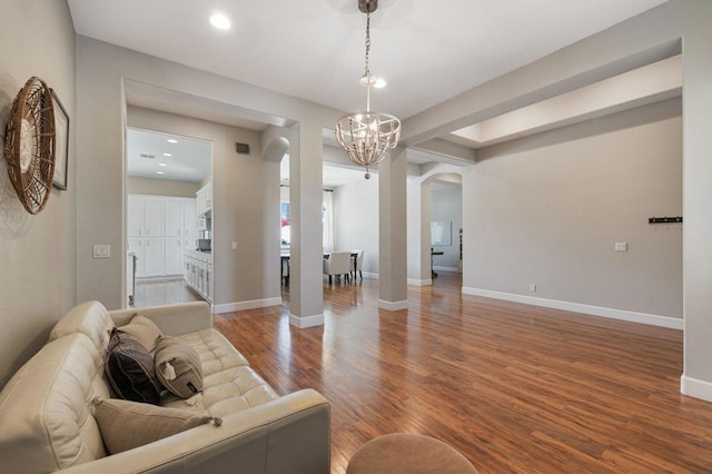 living room featuring a notable chandelier and hardwood / wood-style floors