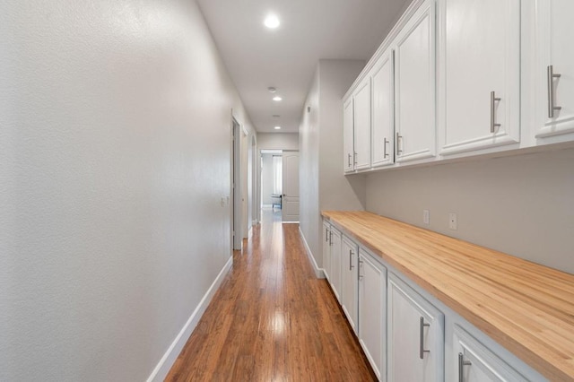 hallway with dark hardwood / wood-style flooring