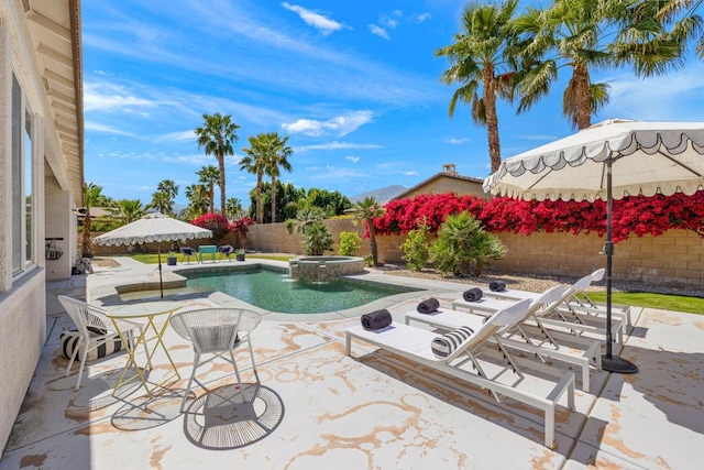 view of pool with a patio area and an in ground hot tub