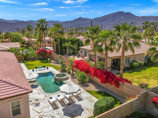 view of pool with a mountain view and a patio