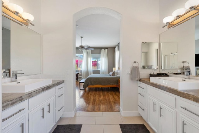 bathroom with ceiling fan, tile patterned flooring, and vanity