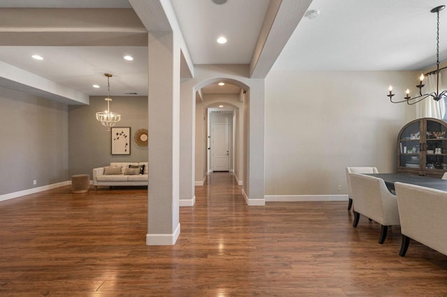 interior space featuring dark wood-type flooring and a notable chandelier