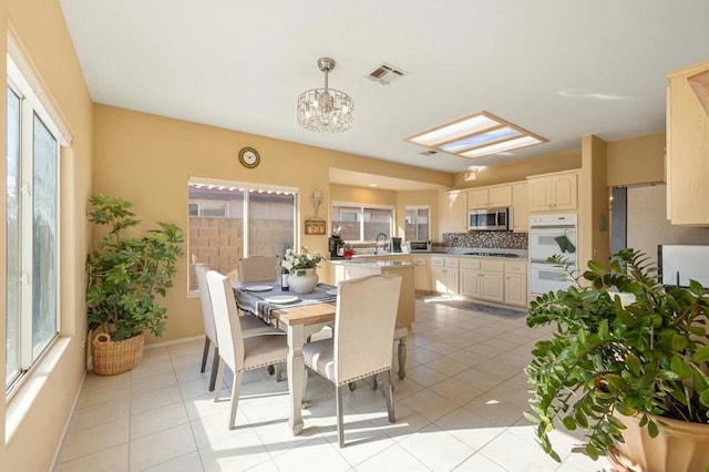 dining space featuring light tile patterned flooring and sink