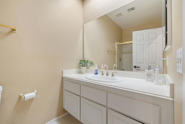 bathroom featuring lofted ceiling, tile patterned floors, vanity, toilet, and walk in shower