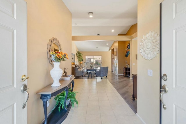 tiled entryway with lofted ceiling