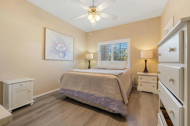 bedroom with ceiling fan and light hardwood / wood-style floors