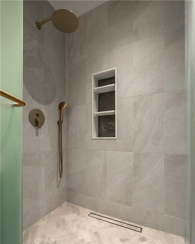 bathroom with a tile shower