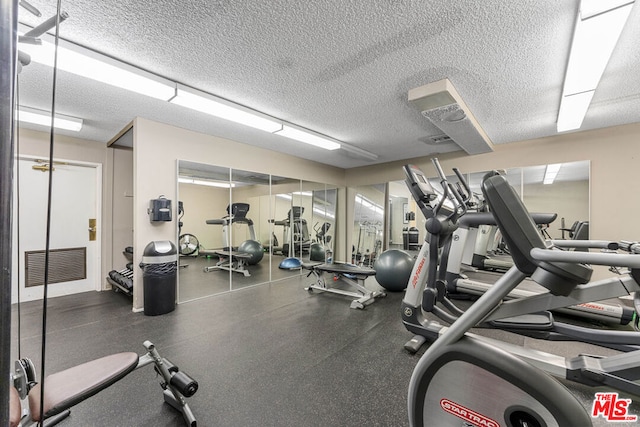 gym with a textured ceiling