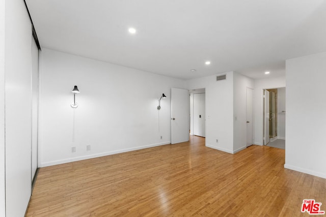 spare room with light wood-type flooring