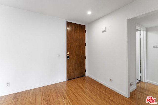 unfurnished room featuring hardwood / wood-style flooring