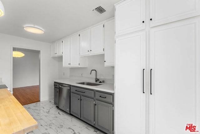 kitchen with gray cabinets, white cabinetry, dishwasher, and sink