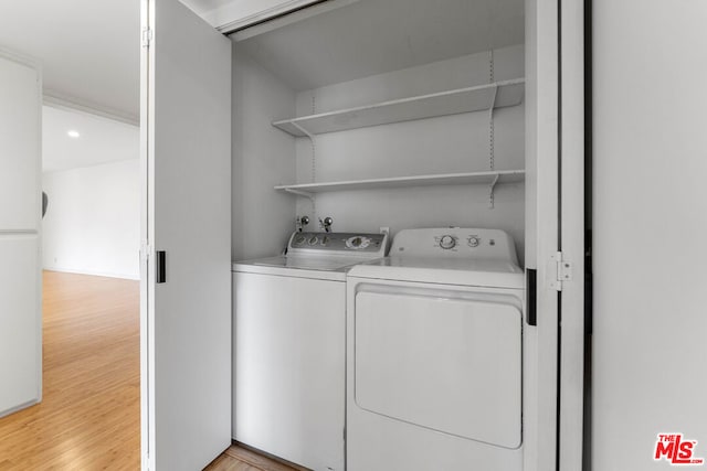 washroom featuring separate washer and dryer and light hardwood / wood-style flooring